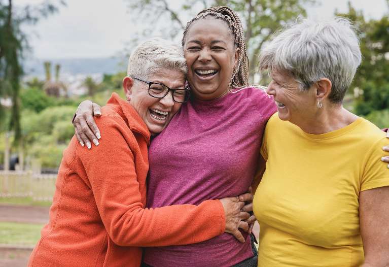 three women smiling and laughing