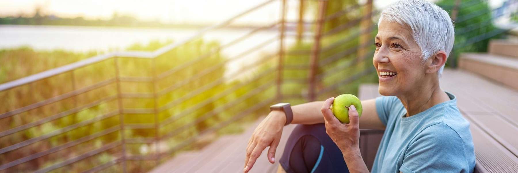 older woman eating an apple
